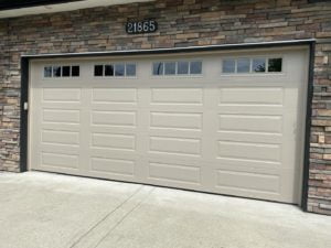 tan garage door on brick home