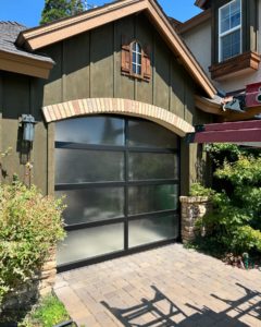 glass garage door on olive green home