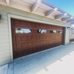 brown wood garage door with windows