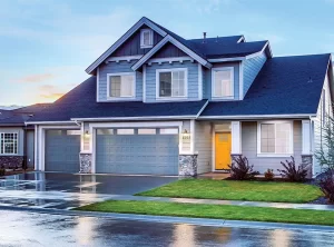 blueish gray home with two garage doors